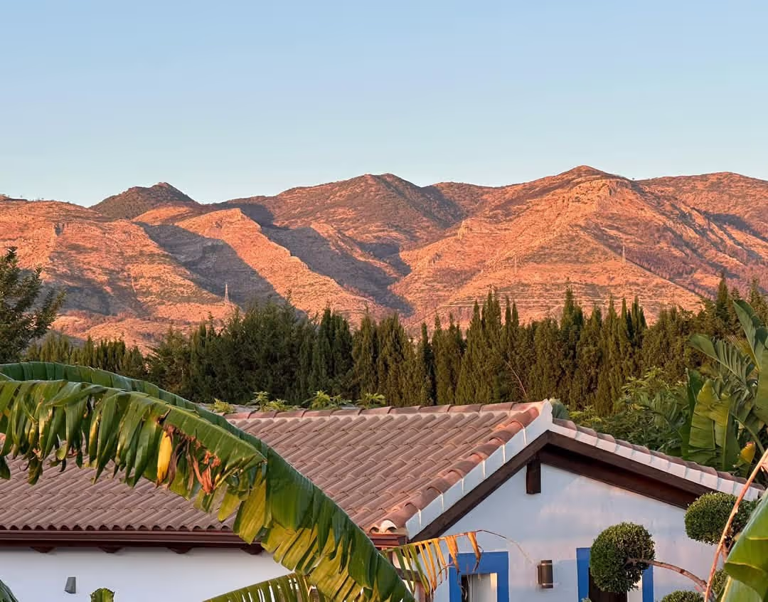 Mountain retreat setting with rolling green hills
