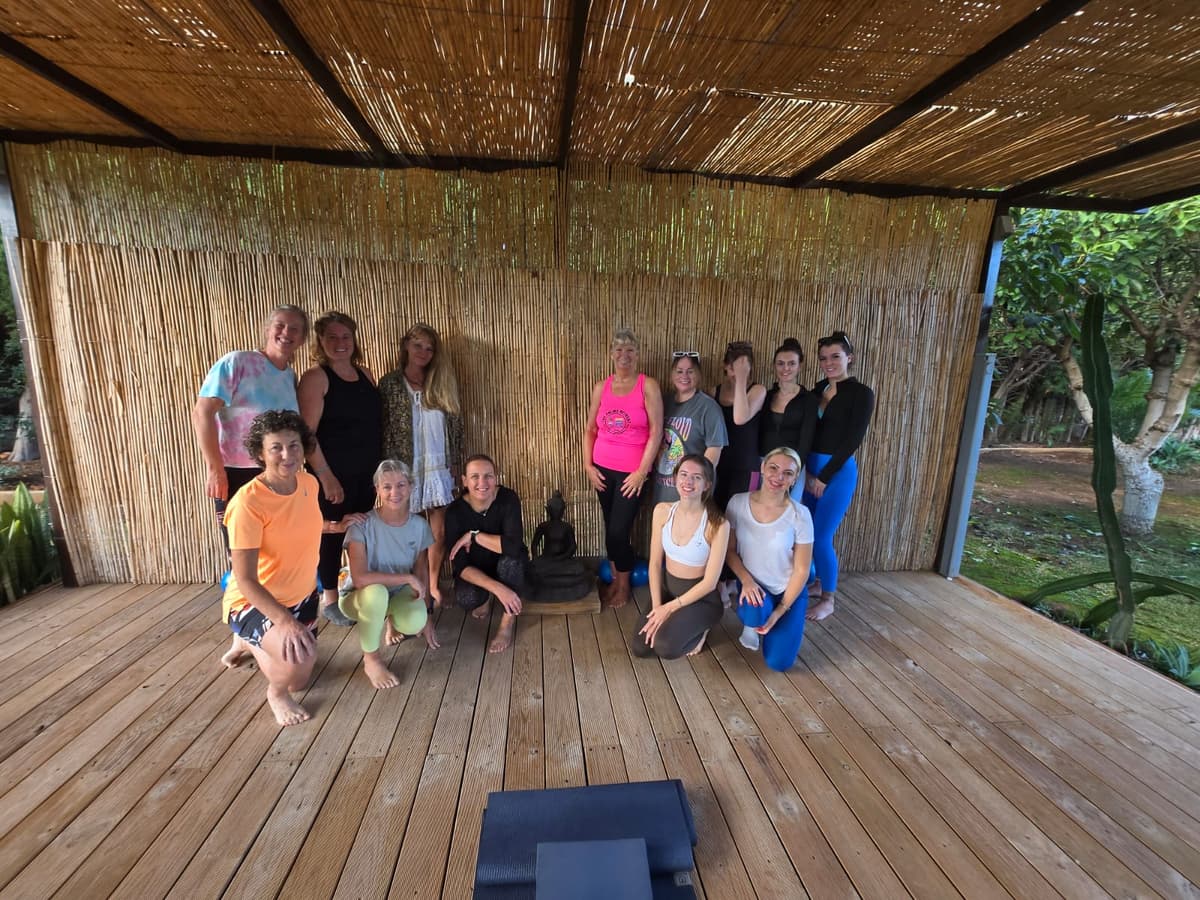 Group photo of retreat participants in the outdoor studio