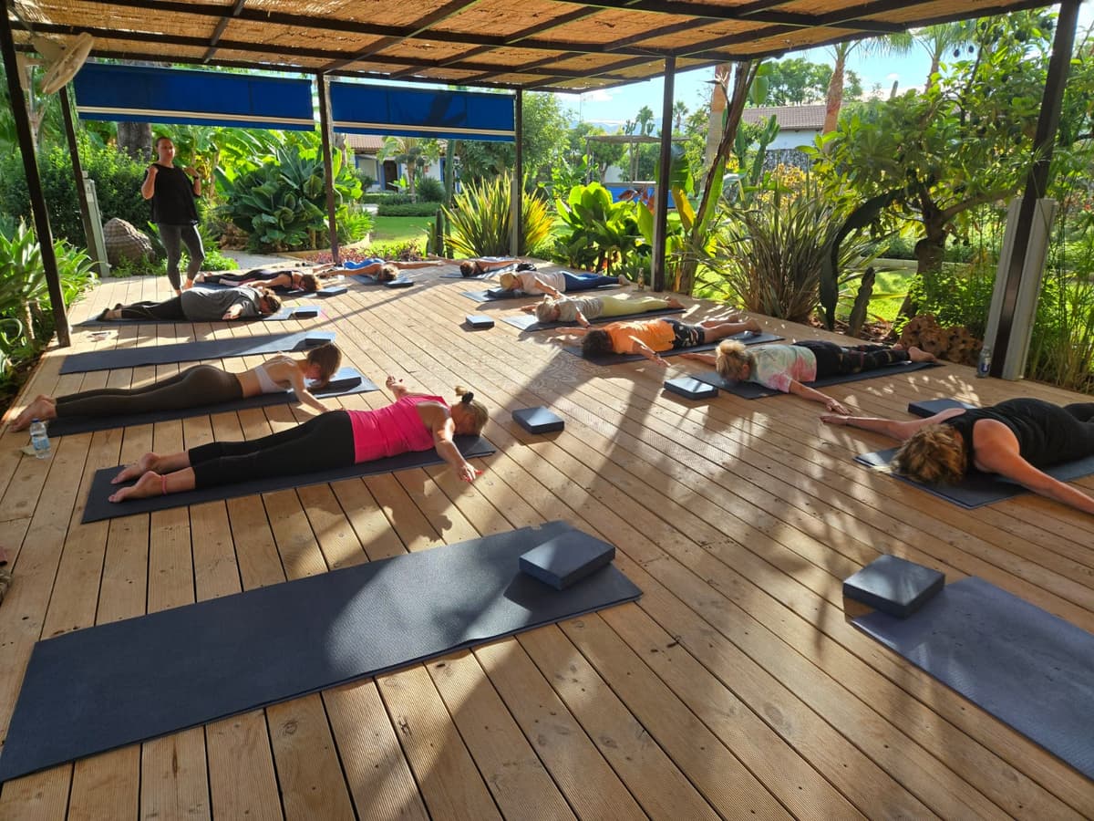 Instructor-led outdoor Pilates session with blocks and mats