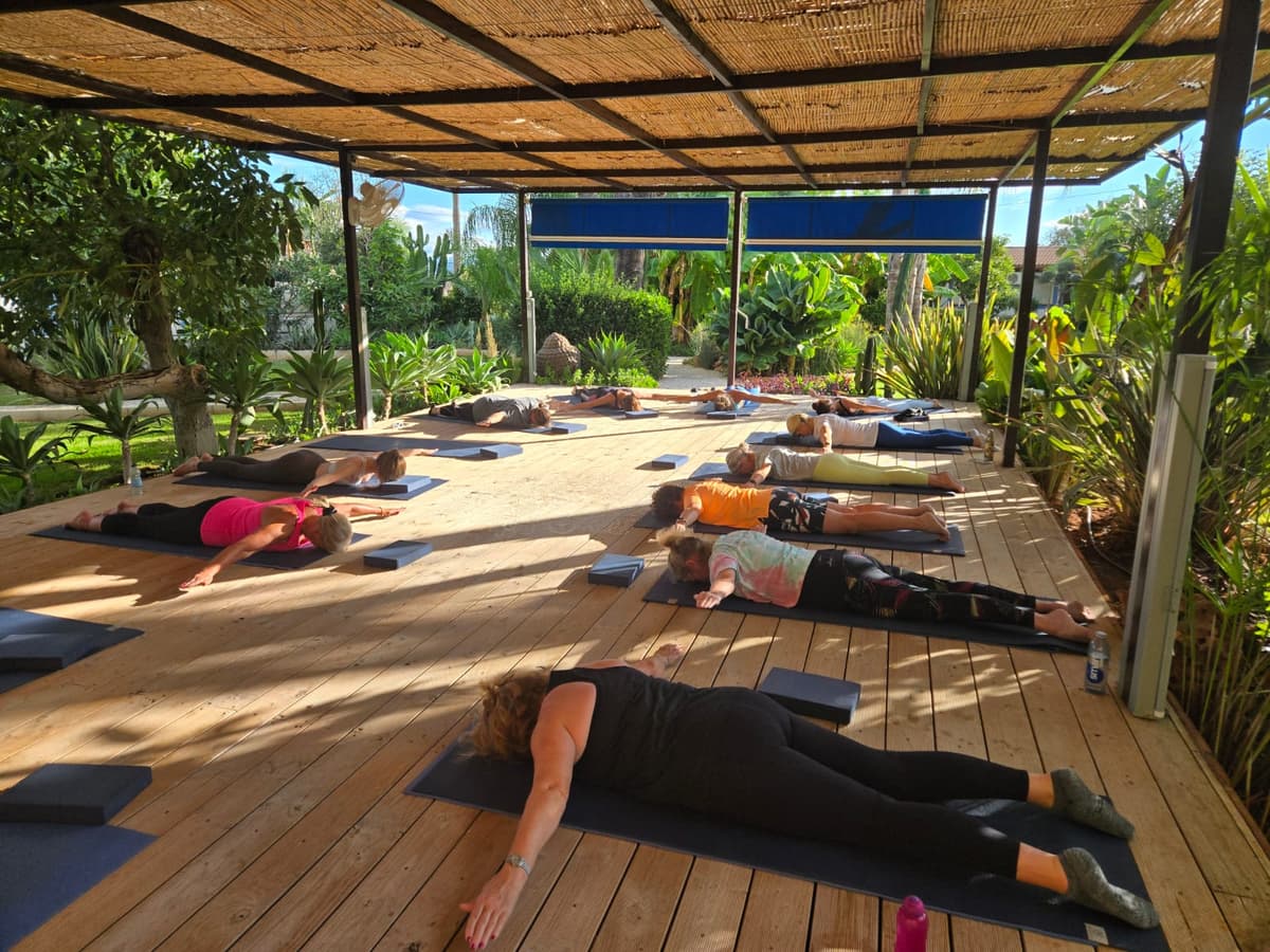 Wide view of group Pilates on the outdoor deck
